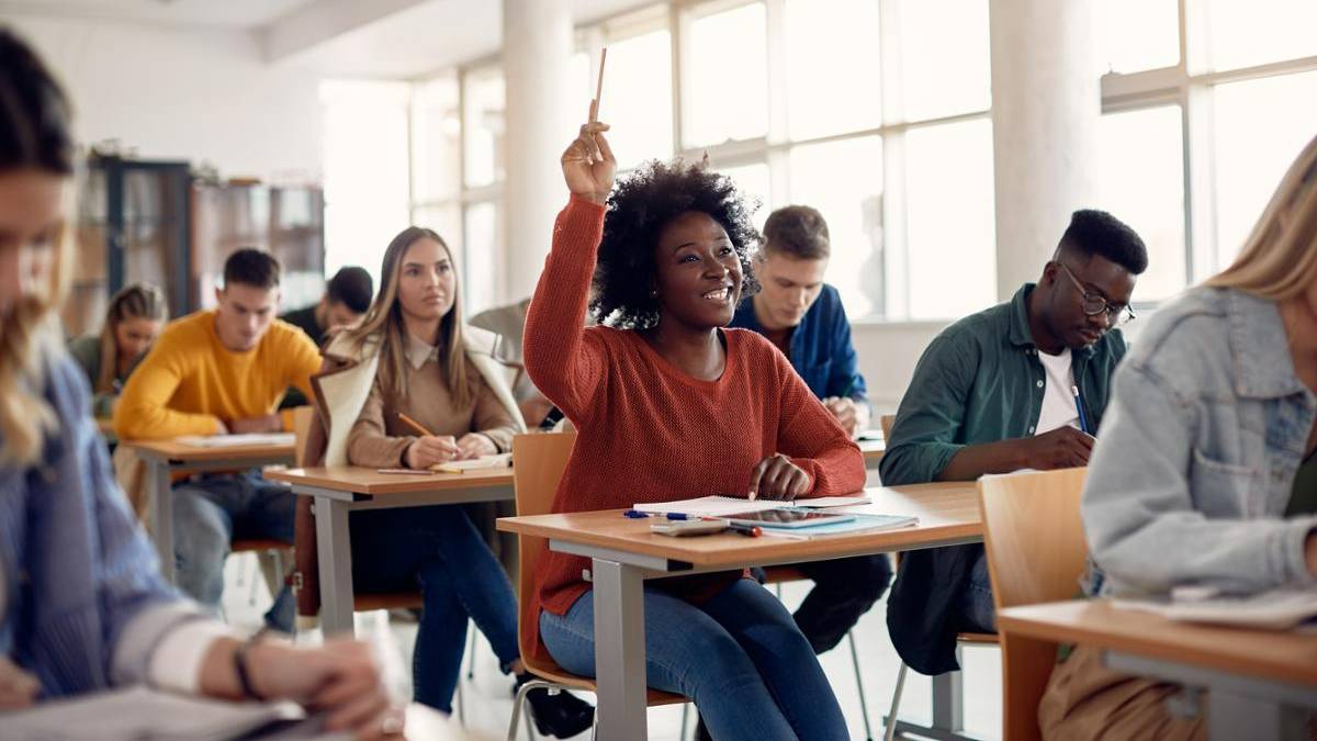 Students in a classroom raising hand