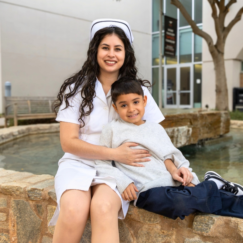 Julisa Merwin Student in nursing uniform with son