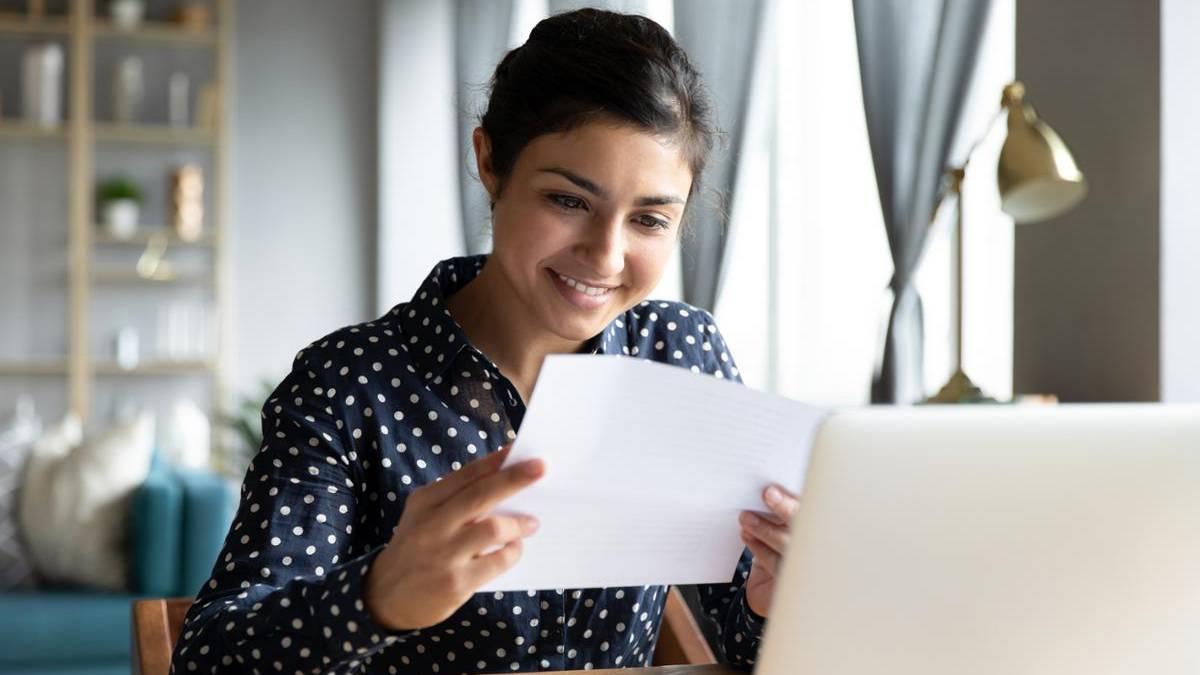 Person smiling looking at a paper. Credit for Prior learning banner