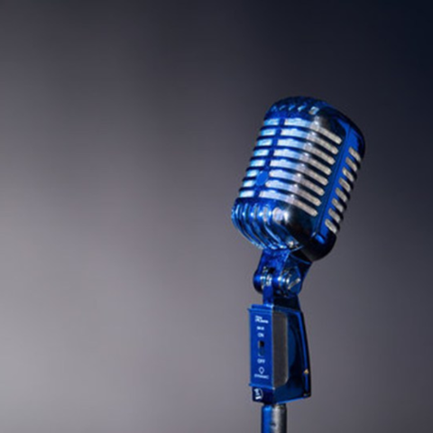 Flyer for Spoken Word Open Mic in the RCC Library on April 23, 2026 from 12:50–1:50 pm on the second floor. Includes image of a microphone and notes that participants may share poems or short stories.