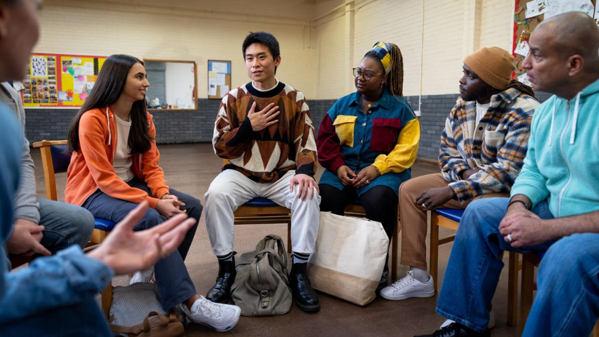 People sitting around a room participating in a counseling session. Mental Health services